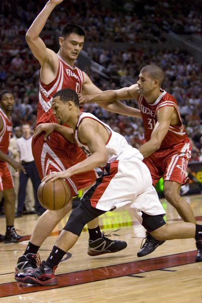 Portland’s Brandon Roy tries to dribble around Houston’s Yao Ming.  (Associated Press / The Spokesman-Review)