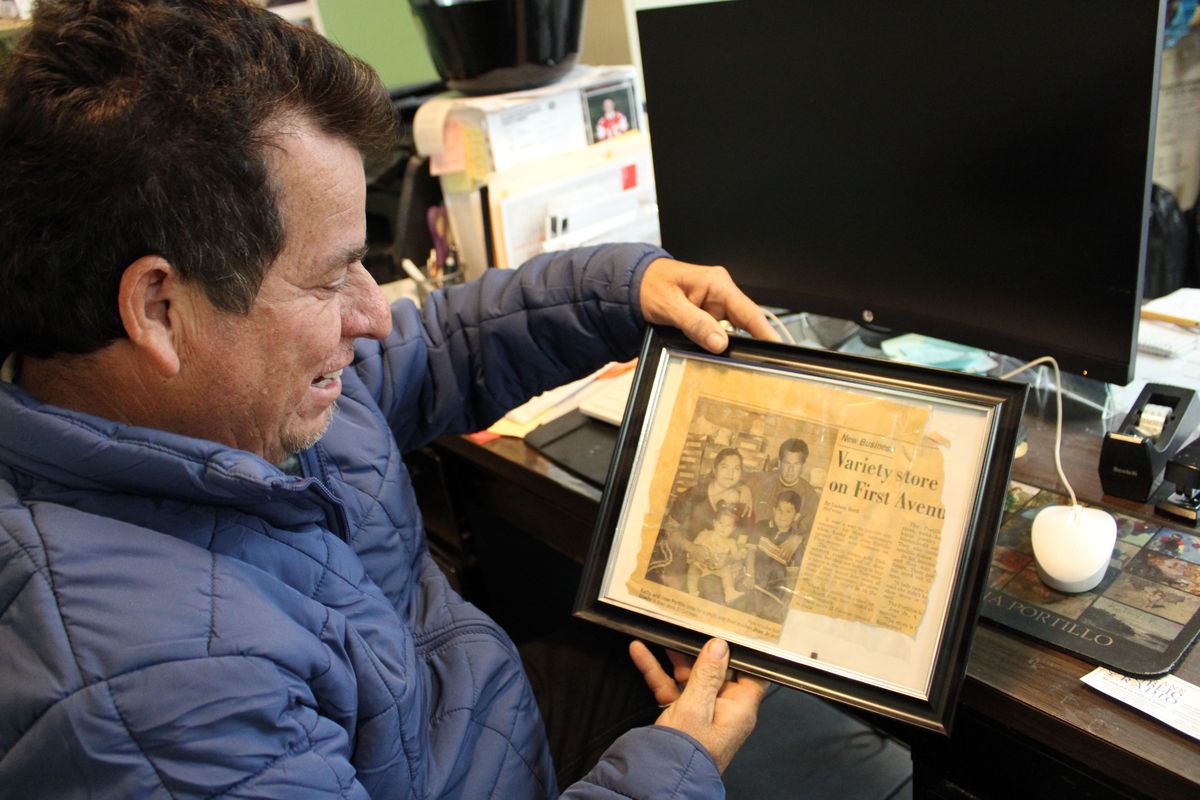 Jose Portillo, longtime owner of El Coliman in Othello, Wash., looks at a framed page of an article a local reporter did for his business. He had opened up his business five months before this article was published.  (Monica Carrillo-Casas/The Spokes)