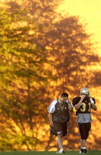 
Idaho linebacker coach Johnny Nansen, left, walks with Shane Simmons following practice Tuesday. 
 (Rajah Bose / The Spokesman-Review)