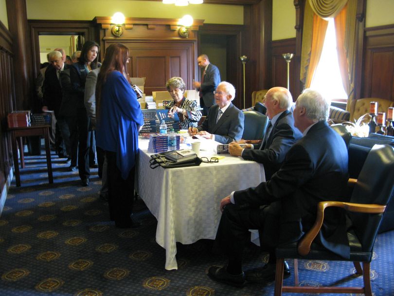 Former Idaho Govs. Cecil Andrus and Phil Batt sign copies of their books for state representatives on Thursday; here, Rep. Shannon McMillan, R-Silverton, is getting hers signed by Batt. (Betsy Russell)