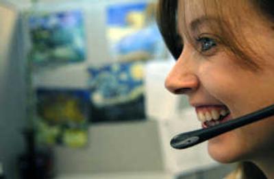 
Ashley French, customer service representative for Jigsaw, a collaborative business information company, talks with a customer at the office in Post Falls. Jigsaw has collected more than 8 million online contacts and sells them to other companies around the globe. 
 (Kathy Plonka / The Spokesman-Review)