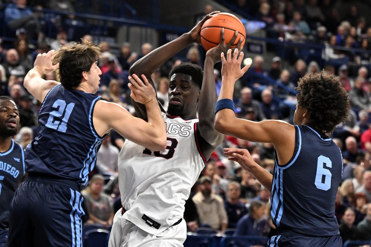 Gonzaga Bulldogs forward Graham Ike (13) looks to pass as San Diego Toreros guard Kody Clouet (21) and San Diego Toreros guard Tony Duckett (6) defend during a NCAA college basketball game, Wed., Jan. 8, 2025, in the McCarthey Athletic Center.  (COLIN MULVANY)