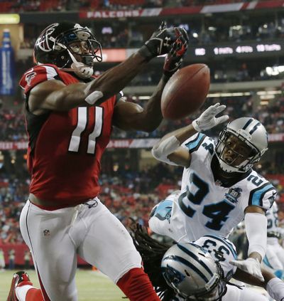 Falcons wide receiver Julio Jones, left, can’t make catch as Panthers cornerback Josh Norman defends. (Associated Press)