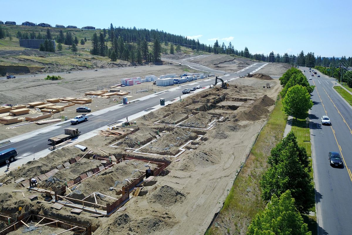 New homes begin to take shape on the east side of Indian Trail Road, at right, at the intersection of Strong Road, Wednesday, June 20, 2018. McCarroll East, the fourth addition to the large subdivision already there, has begin construction on 21 luxury homes. (Jesse Tinsley / The Spokesman-Review)