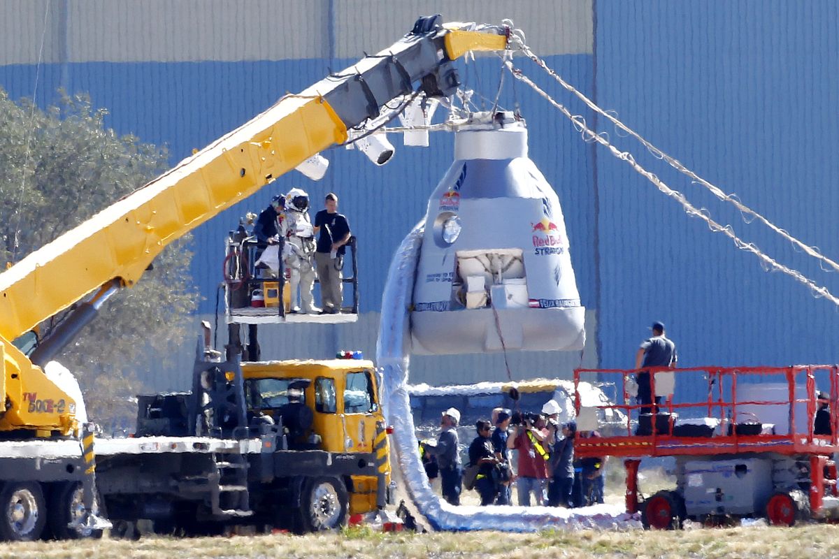 Felix Baumgartner, in pressurized suit on platform at left, prepares to enter the balloon capsule in Roswell, N.M. on Tuesday, Oct. 9, 2012. Baumgartner will attempt to break the speed of sound with his own body by jumping from the space capsule lifted by a 30 million cubic foot helium balloon. Baumgartner plans to jump from an altitude of 120,000 feet - an altitude chosen to enable him to achieve Mach 1 in freefall - which will deliver scientific data to the aerospace community about human survival from high altitudes. (Matt York / Associated Press)