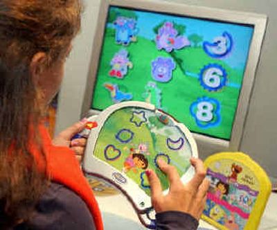 
Nicole Morson, 12, of Bethlehem, Pa., uses an InteracTV by Fisher Price, one of the Toy Wishes magazine 2004 Hot Dozen. 
 (Associated Press / The Spokesman-Review)