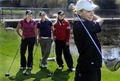 Watching Marli Mikulecky tee off are, from left, fellow all-league Eagles Kristina Gargaro, Chloe Nelson, Kellie Holmstedt.
(CHRISTOPHER ANDERSON / The Spokesman-Review)