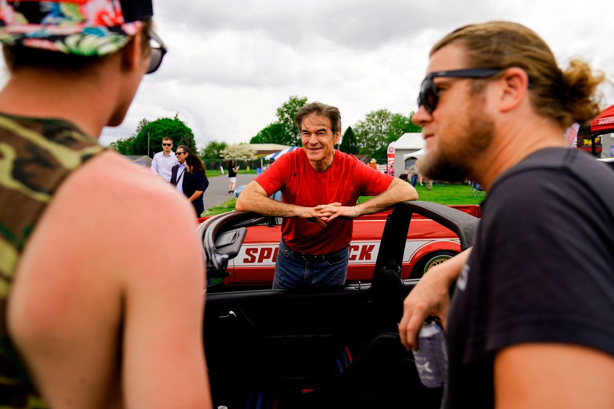 Mehmet Oz, a Republican candidate for U.S. Senate in Pennsylvania, meets with attendees during a visit to a car show in Carlisle, Pa., Saturday, May 14, 2022.  (Matt Rourke)