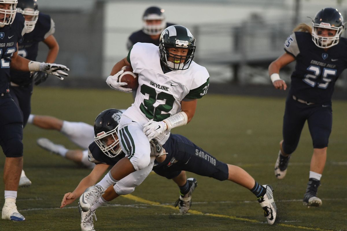 Skyline running back Isaiah Shim (32) scores the Spartans’ first touchdown on a 68-yard run during the first half of a high school football game at Gonzaga Prep, Friday, Sept. 9, 2016, in Spokane, Wash. (Colin Mulvany / The Spokesman-Review)