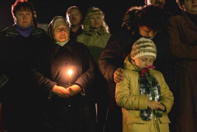 
Ukrainians participate in a ceremony Tuesday to commemorate those who died after the Chernobyl nuclear disaster, at the memorial to Chernobyl firefighters in the city of Slavutich. 
 (Associated Press / The Spokesman-Review)