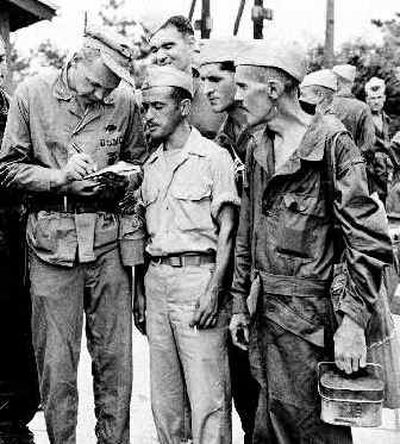 
 In this Sept. 14, 1945, photo, war correspondent Mac R. Johnson of the New York Herald Tribune, left, interviews released prisoners of war in Yokohama, Japan, left to right: Pfc. William J. Liberia of Buffalo, N.Y., captured at Bataan; Pvt. Millard A. Orsini of Altamont, N.Y., captured at Bataan; and Pfc. Ralph J. Currier of Ballston Spa, N.Y., captured at Corregidor. Orsini made a U.S flag on paper filched from his Japanese captors. The restored 48-star flag now hangs in his hometown. 
 (File/Associated Press / The Spokesman-Review)