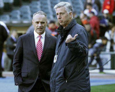Commissioner Rob Manfred, left, talks with Boston’s Dave Dombrowski before a game. (Charles Rex Arbogast / Associated Press)