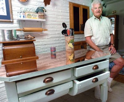 
Richard Fode sits by his mother's old dough table that he spent about a month refinishing to near-new condition. 
 (Joe Barrentine / The Spokesman-Review)