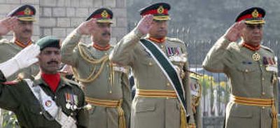 
President Gen. Pervez Musharraf, center,  salutes during an honor guard ceremony at the armed forces headquarters in Rawalpindi, Pakistan, on Tuesday. Musharraf visited troops to bid them farewell, a day before standing down as military chief.Associated Press
 (Associated Press / The Spokesman-Review)