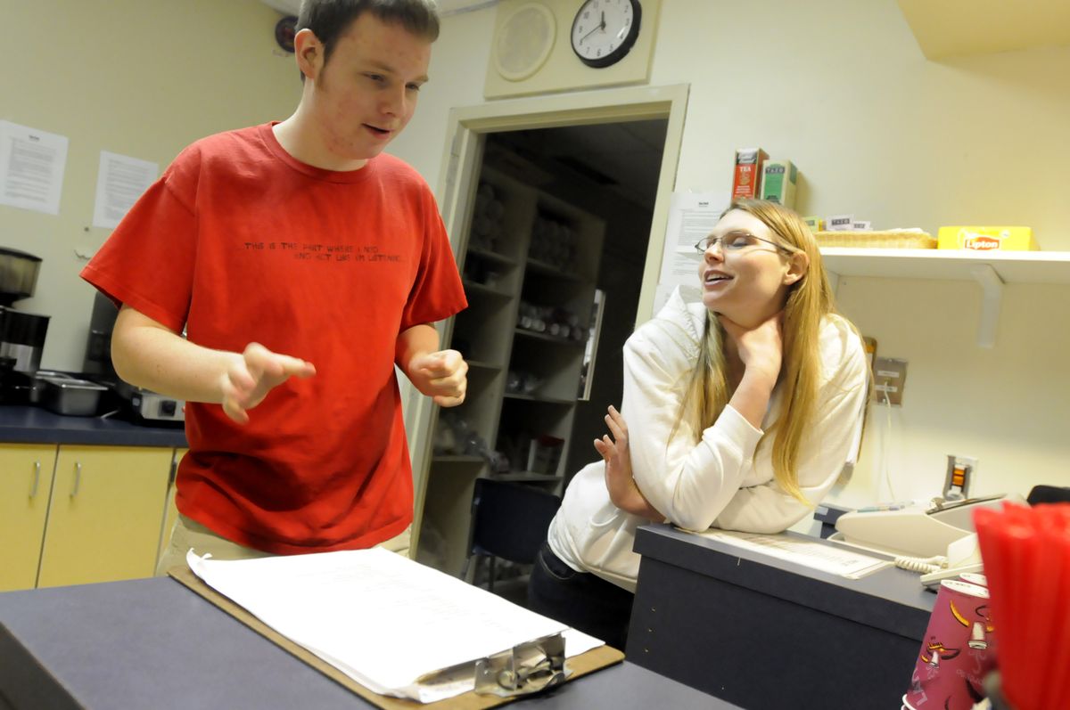 Dillon Monday, 18, left, talks with Laura Bergmann, a para-educator, about what he should be doing inside the coffee shop at Mead High School. Monday is autistic and gets vocational training through his work in the school’s espresso stand. Bergmann is Monday’s classroom aide.  (Jesse Tinsley / The Spokesman-Review)