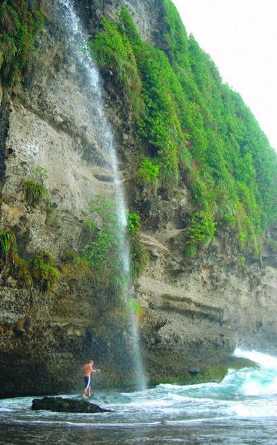 
A visitor bathes on Secret Beach near Portsmouth, Dominica in this October 2006 photo. This jagged, densely rainforested island, about 29 miles long and 16 miles wide, is located between Guadeloupe and Martinique in the Eastern Caribbean, 375 miles southeast of San Juan, Puerto Rico. 
 (Associated Press photos / The Spokesman-Review)