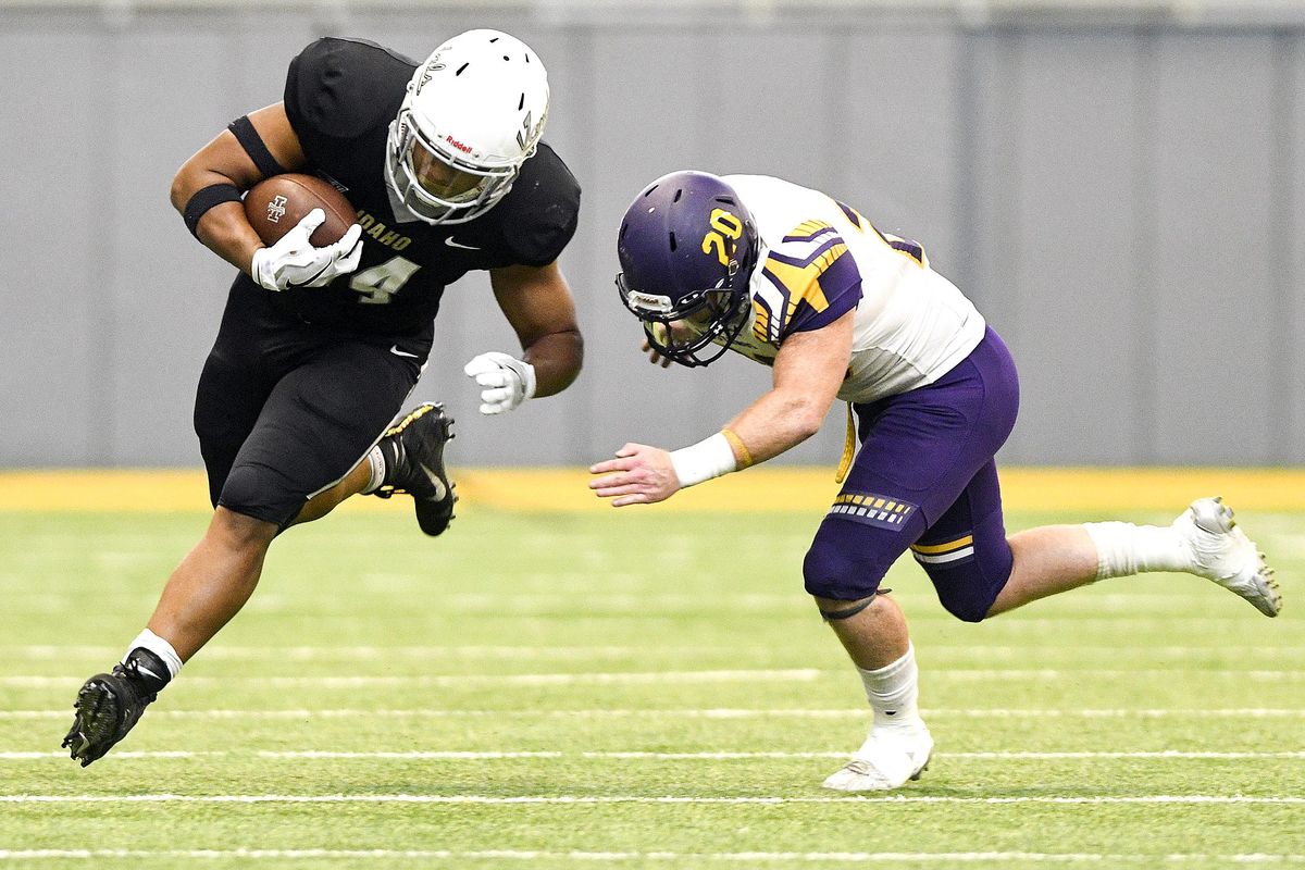 Idaho Vandals running back Roshaun Johnson  runs around the corner as Western New Mexico’s Collin Grady looks to make a tackle during the second quarter of a nonconference game Saturday afternoon at the Kibbie Dome in Moscow, Idaho. (Pete Caster / Lewiston Tribune)