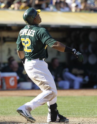 Oakland’s Yoenis Cespedes watches his game-winning home run leave the park in the eighth inning Sunday. (Associated Press)