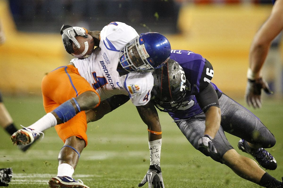 Boise State receiver Titus Young is stopped by TCU safety Jurell Thompson. (Associated Press)