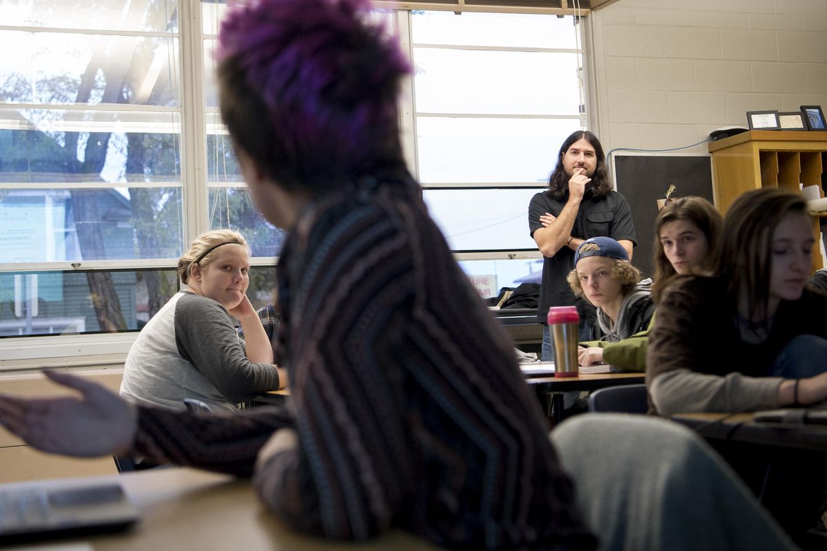 Teacher David Egly listens as Claire Reid, 17, senior, speaks during a civics class  Thursday, Oct. 20, 2016, at The Community School in Spokane, Wash. The class is presented the research they’ve done on this year’s various candidates in preparation for a mock vote next week. (Tyler Tjomsland / The Spokesman-Review)