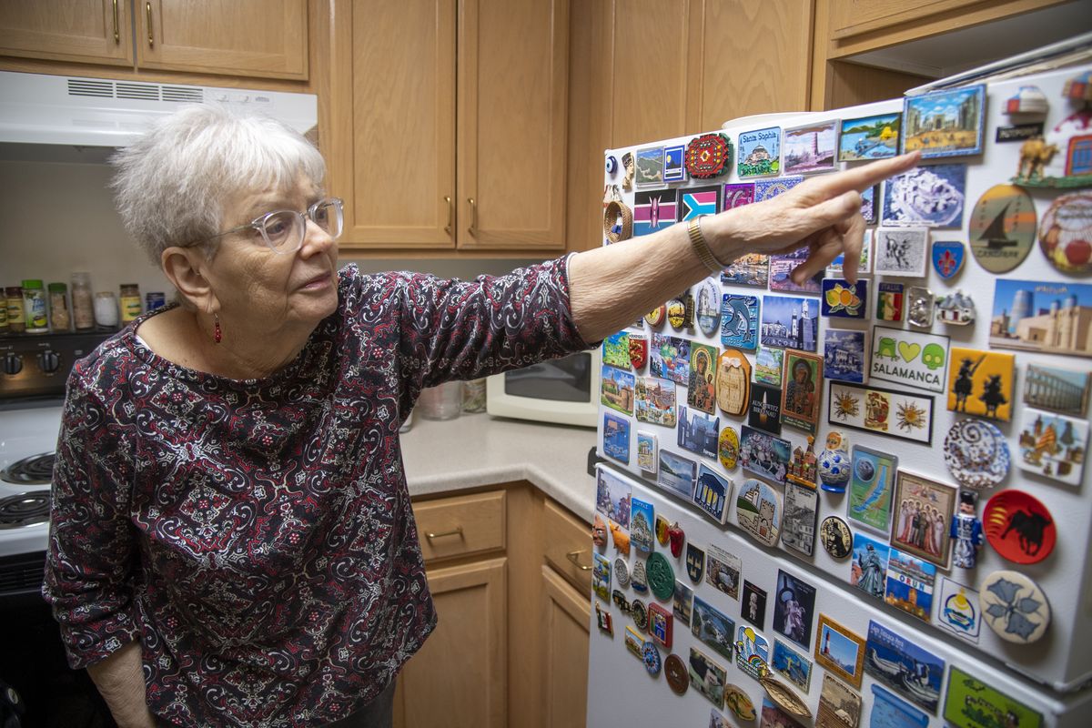 Jessie Lang, who lives at Orchard Crest in Spokane Valley, points to some of her dozens of refrigerator magnets that remind her of her traveling adventures to Europe, Africa, Asia, South America and Antarctica of the past few decades. She has been traveling as much as she can afford and bringing home only tiny reminders of her travels.  (Jesse Tinsley/THE SPOKESMAN-REVIEW)