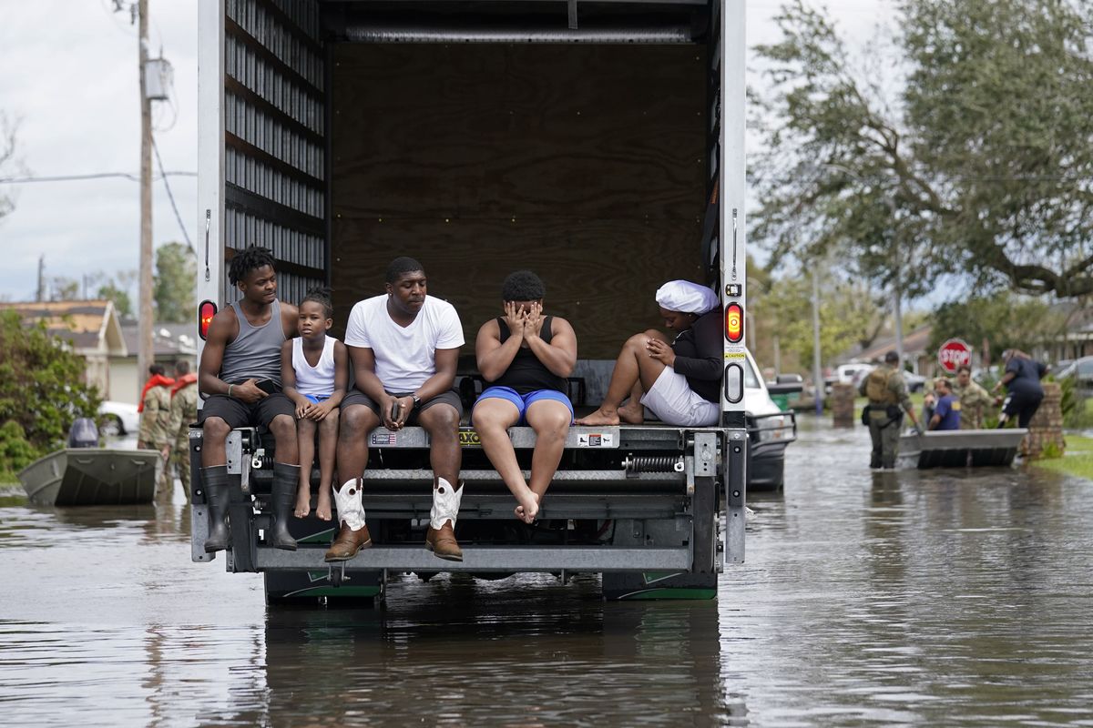 People are evacuated from floodwaters Monday in the aftermath of Hurricane Ida in LaPlace, La.  (Gerald Herbert)