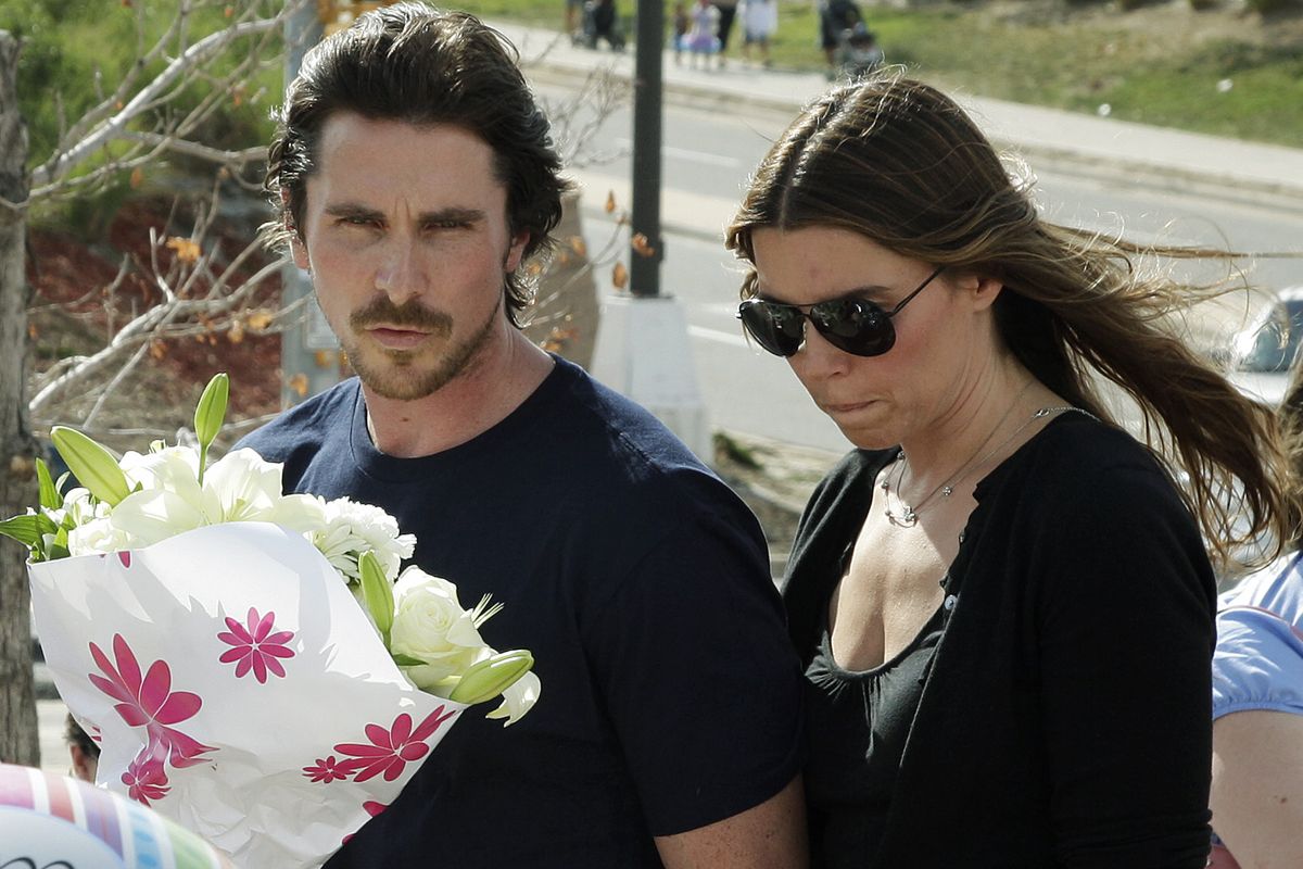 Actor Christian Bale and his wife, Sibi Blazic, visit a memorial to the victims of Friday