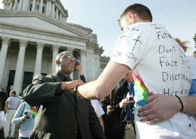 
The Rev. Harvey Drake, left, of the Emerald City Bible Fellowship, who opposes gay marriage, talks with Ryan Olson, right, a Gonzaga University student, who supports it. 
 (Associated Press / The Spokesman-Review)