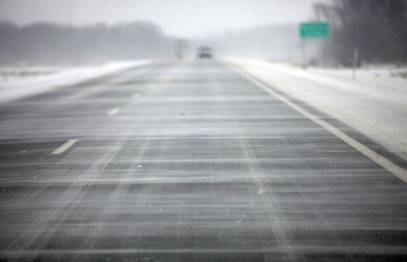 Snow blows across south bound US Route 131 in Kalamazoo, Mich. on Thursday, Jan. 2, 2014. A multi-day storm dropped up to a foot of snow on parts of Michigan, causing crashes and spinouts on roadways. Snowfall began Tuesday and continued Thursday morning. (Mark Bugnaski / Kalamazoo Gazette-mlive Media Group)