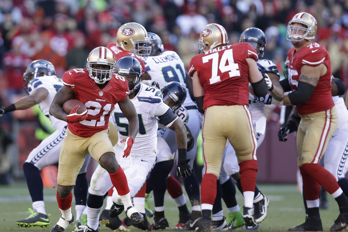 San Francisco’s Frank Gore runs away from Seattle linebacker Bruce Irvin (51) during the second half of the 49ers’ victory. (Associated Press)