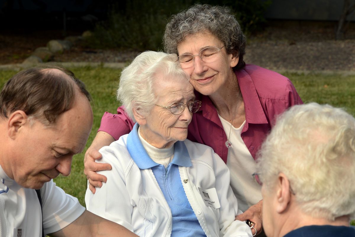 Lynda Bowen, center right, gives a hug to Sister Bernadette Delourdes during a reunion of residents of the former St. Joseph Children’s Home and the Sisters of St. Francis of Philadelphia on Sept. 23 in Spokane. (PHOTOS BY DAN PELLE)