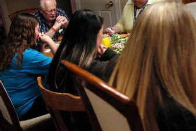 
House parent Bill Walters leads the blessing before dinner with teen residents of the Life Services Maternity Home in Spokane on Thursday. 
 (Holly Pickett / The Spokesman-Review)