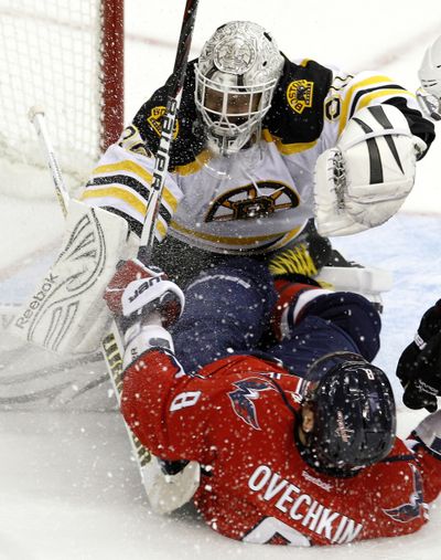 Washington’s Alex Ovechkin collides with Boston Bruins goalie Tim Thomas after Thomas deflected his point-blank shot. (Associated Press)