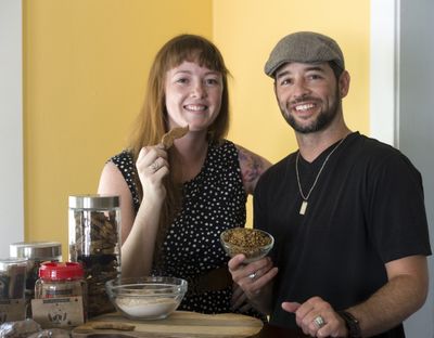 Katie Wardall, left, and Pete Franz produce dog treats, which are made up of spent grains from beer brewing, at their North Side home. The leftover grains make up about 50 percent of each dog treat, which they sell under their brand name, The Malted Mutt. (Jesse Tinsley)