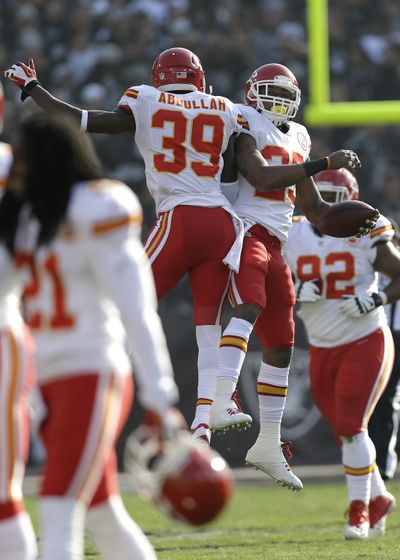 Chiefs’ Eric Berry, top right, celebrates with Husain Abdullah after returning an interception for a score. (Associated Press)