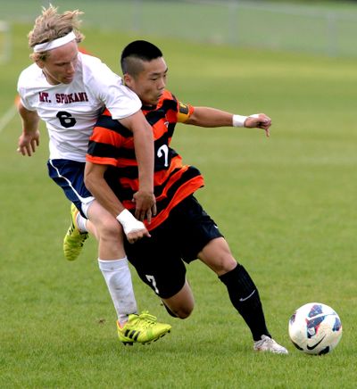 Taming the Tigers: Mt. Spokane’s Brady Moore, right, and Lewis and Clark’s Tyrus LaRocca battle for the ball on the final day of Greater Spokane League soccer season Friday. The host Wildcats defeated LC 5-0 to win the league title and will be the No. 1 seed at the District 8 3A tournament. They will play No. 4 seed North Central on Wednesday at Albi Stadium. In the District 8 4A on Tuesday at Spokane Falls CC, No. 1 Ferris will play No. 2 Central Valley for the district championship and No. 3 LC will play No. 4 Mead in a loser-out match. (Colin Mulvany)