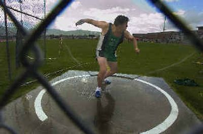 
Tyler Jolley of East Valley spins to unleash a throw in the discus. He finished second at 143-11. 
 (Christopher Anderson/ / The Spokesman-Review)