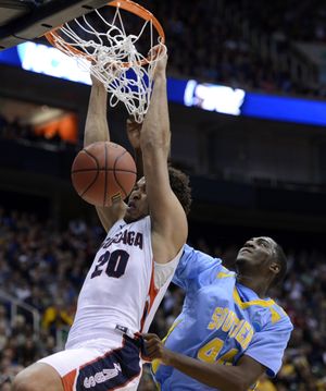 Gonzaga's Elias Harris slams a rebound dunk over Southern's Javan Mitchell in the first half of their second round NCAA men's college basketball tournament game, Thursday, March 21, 2013, at the EnergySolutions Arena in Salt Lake City, Utah. (The Spokesman-Review)