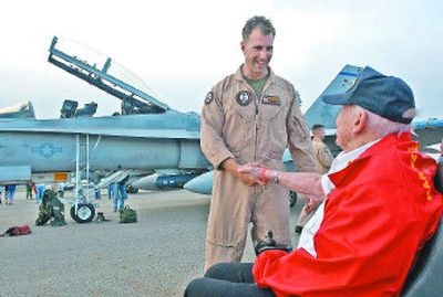 
Marine Capt. Kristian Larsen shakes hands with Garth Haddock, a World War II pilot who flew with the Black Sheep Squadron, at the Coeur d'Alene Airport on Friday.  Larsen, who is stationed in Southern California, arranged a training flight back to his hometown of Coeur d'Alene and asked to meet Haddock. 
 (Jesse Tinsley / The Spokesman-Review)