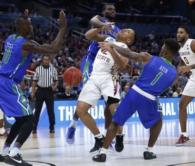 Florida State guard CJ Walker (2) is fouled as he goes up for a shot against Florida Gulf Coast forward Marc-Eddy Norelia, rear, guard Reggie Reid (1) and guard Christian Terrell (11) during the second half of the first round of the NCAA college basketball tournament, Thursday, March 16, 2017 in Orlando, Fla. (Wilfredo Lee / Associated Press)