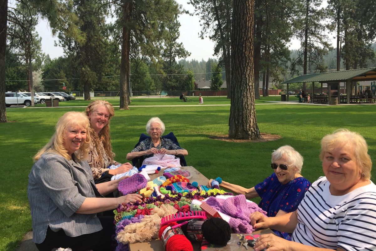 From left, Donna Gard, Karen Gallion and Lorraine Henry meet up with Ida Remington and Brigitte Hall at Edgecliff Park in Spokane Valley. The women are part of a group of volunteers who knit and crochet hats for the RSVP program which produced 8,000 hats for the needy last year. (Pia Hallenberg / The Spokesman-Review)