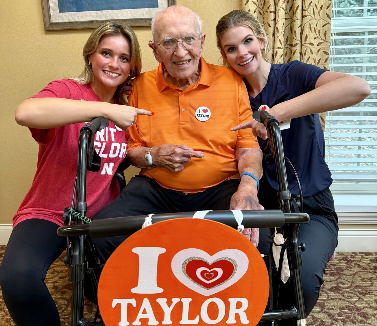 Maddy Beecham, left, and Sarah Zajic hang out with Frank Uryasz Jr. and his Taylor Swift-decorated walker.
