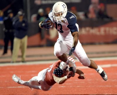 Northern Arizona University’s Kendyl Taylor dodges the grasp of Eastern Washington’s Cole Karstetter at EWU’s Roos Field on Saturday. The Lumberjack’s handled the Eagles 52-30. (Jesse Tinsley / The Spokesman-Review)