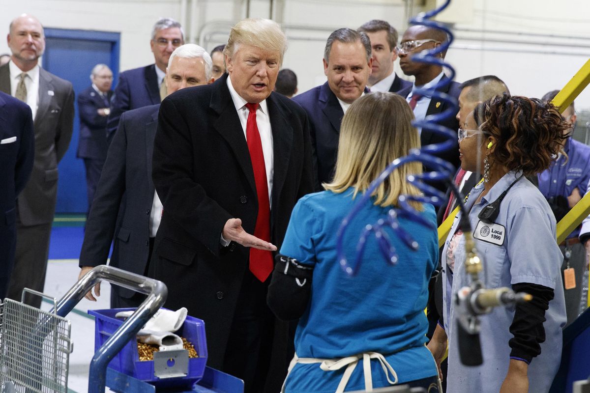 In this Dec. 1, 2016,  photo, President-elect Donald Trump greets workers during a visit to the Carrier Corp. factory in Indianapolis. The $7 million deal to save jobs at the Carrier factory in Indianapolis is poised for approval by state officials nearly four months after President Donald Trump celebrated his role in the negotiations with a post-election visit to the plant. (Evan Vucci / Associated Press)