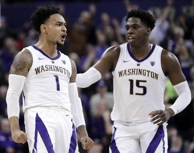 Washington guard David Crisp, left, celebrates with forward Noah Dickerson  during overtime in  against Oregon State on Wednesday  in Seattle. (Ted S. Warren / AP)