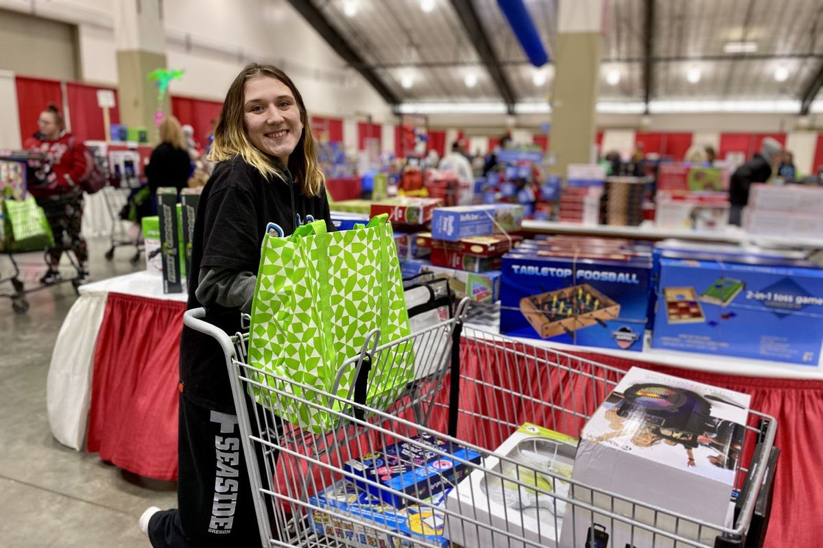 Paige Savage looks for gifts for her 13-year-old sister, 11-year-old brother and 2-year-old son at the Christmas Bureau on Tuesday.  (Roberta Simonson/The Spokesman-Review)