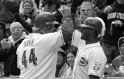 
Reds' Adam Dunn, left, is congratulated by Ken Griffey Jr. after gift home run. 
 (Associated Press / The Spokesman-Review)