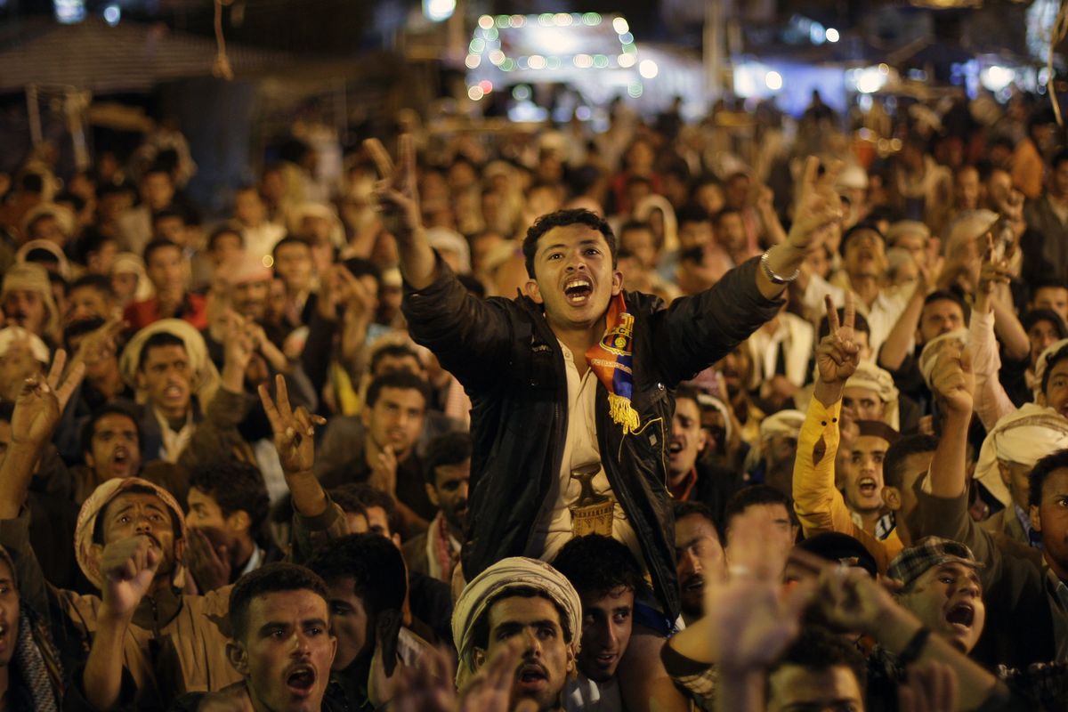 Protesters react in Sanaa, Yemen, on Sunday after receiving the news of the departure of Yemen’s President Ali Abdullah Saleh from the country. (Associated Press)