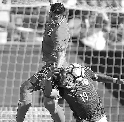 Costa Rica’s Johnny Acosta, top, and Paraguay’s Dario Lezcano  collide during Saturday’s Copa America  soccer match. (Stephen M. Dowell / Associated Press)