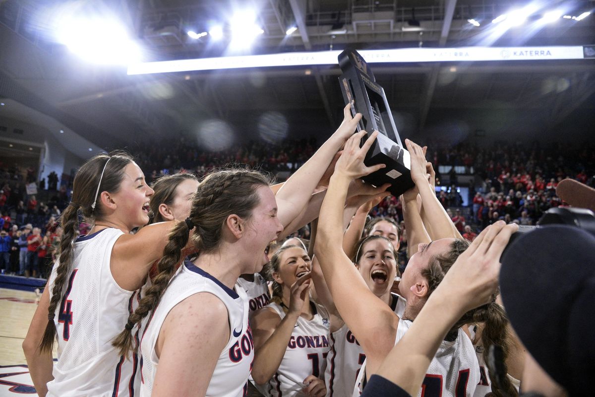 Gonzaga players hold the WCC championship trophy aloft after defeating BYU, Saturday, Feb. 24, 2018, in the McCarthey Athletic Center. (Dan Pelle / The Spokesman-Review)